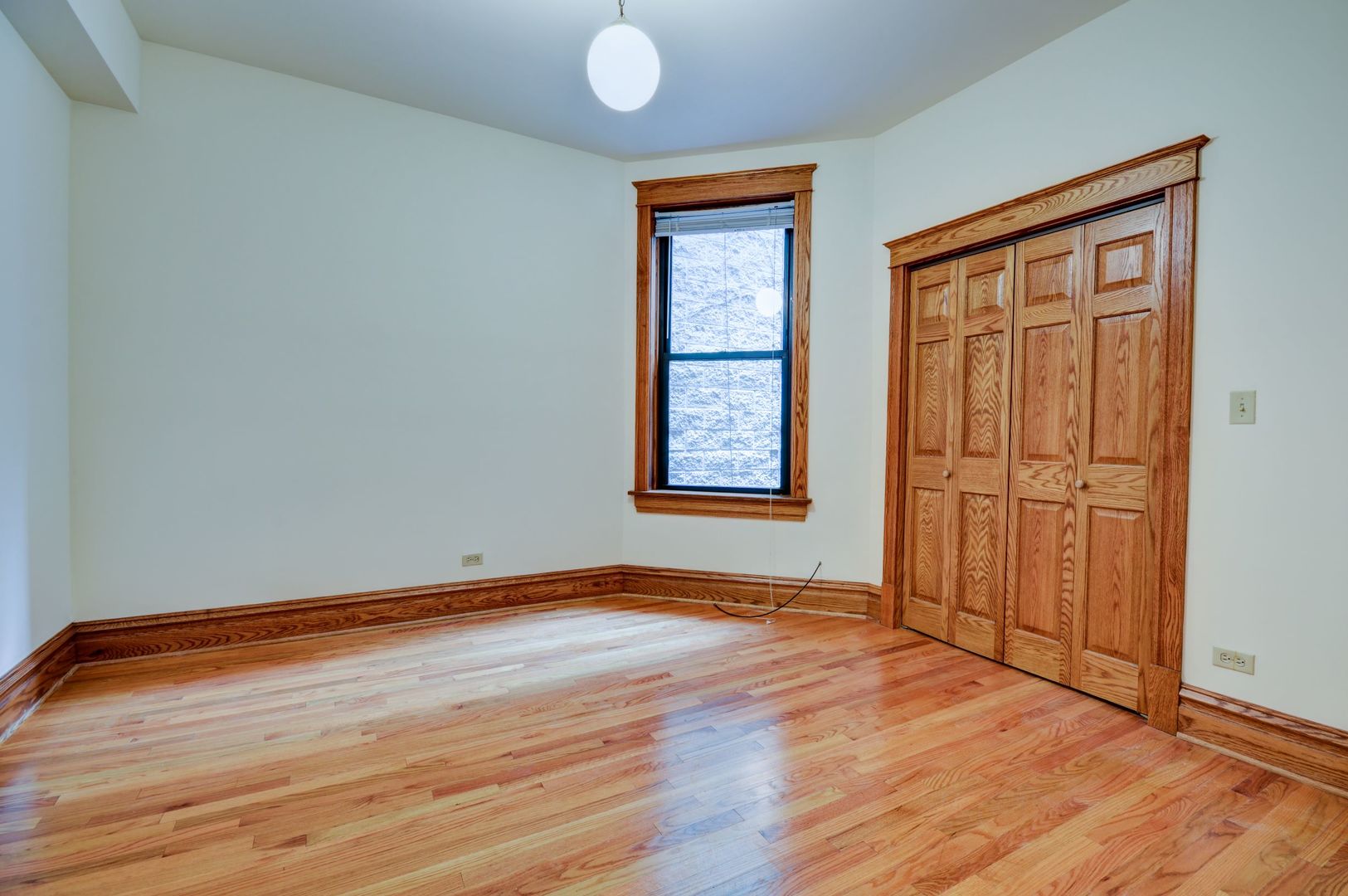 3722 North Fremont Street, Unit 2 Chicago, IL 60613 - Photo 11 of 16 an empty room with wooden floor and windows