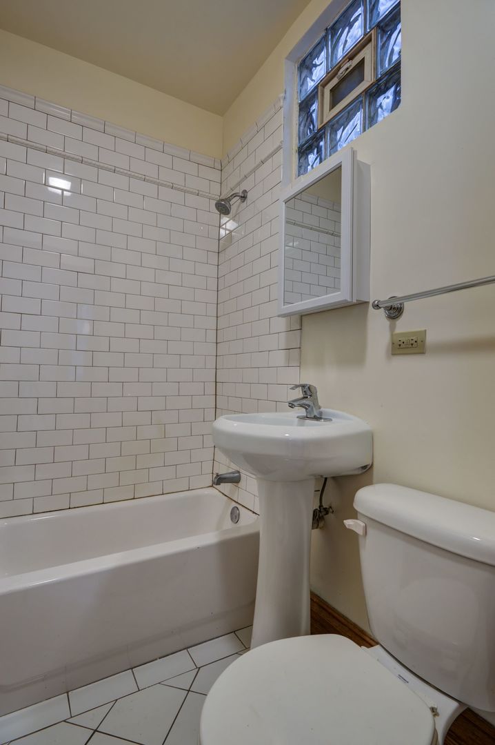 3722 North Fremont Street, Unit 2 Chicago, IL 60613 - Photo 15 of 16 a bathroom with a sink a toilet and shower