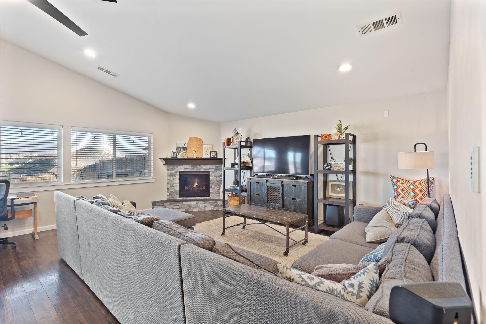 110 Linton Way Eagle Point, OR 97524 - Photo 6 of 41 a living room with furniture a fireplace and a floor to ceiling window