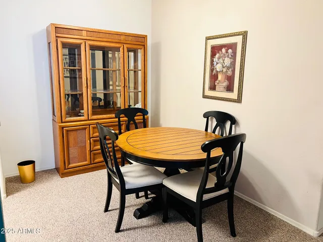 a dining room with furniture and window