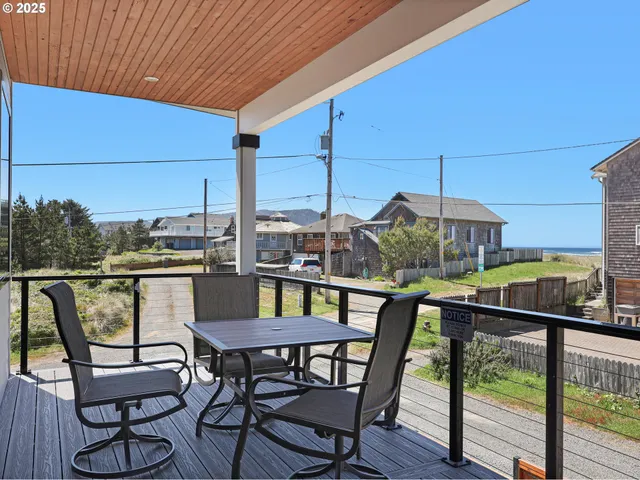 a view of a chairs and table in the balcony