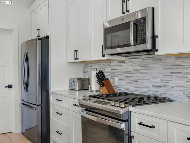 a stove top oven sitting inside of a kitchen