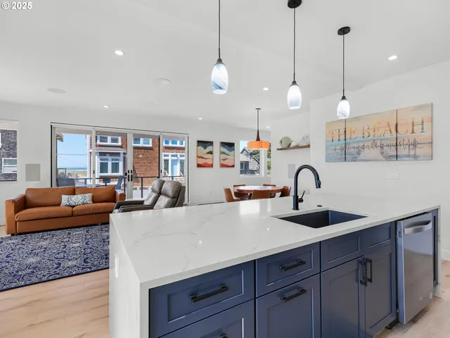 a very nice looking kitchen with granite countertop a sink a counter space appliances and cabinets