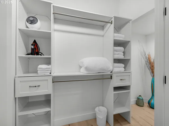 a living room with white cabinets and a potted plant