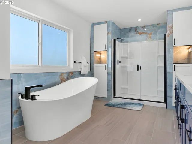 a white bath tub sitting in a en suite bathroom