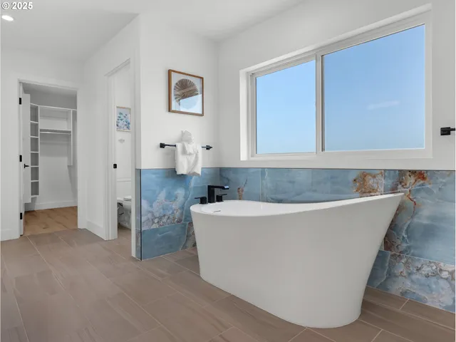 a living room with furniture and large window