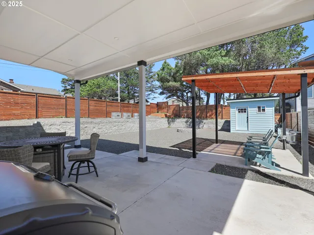 a patio with glass top table and chairs