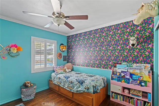 a bedroom with bed and a book shelf