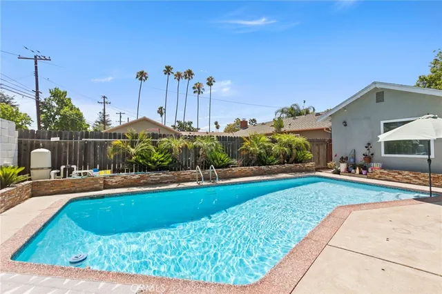 a view of a house with swimming pool and a yard