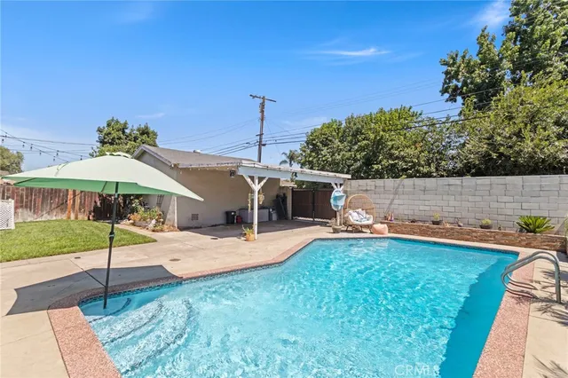 a backyard of a house with table and chairs