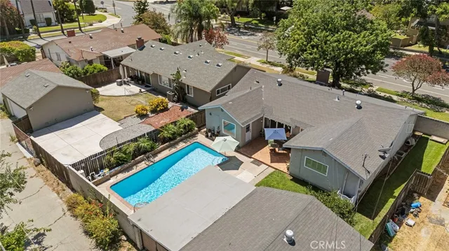 an aerial view of a house with a yard