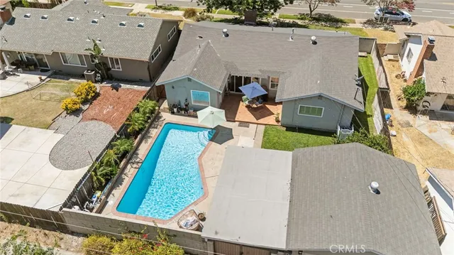 an aerial view of a house with a yard and sitting area