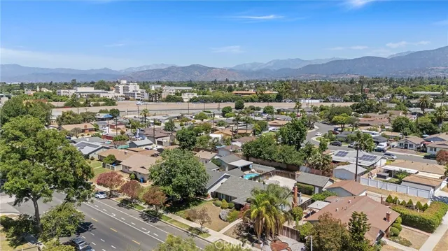 a front view of a house with garden and trees