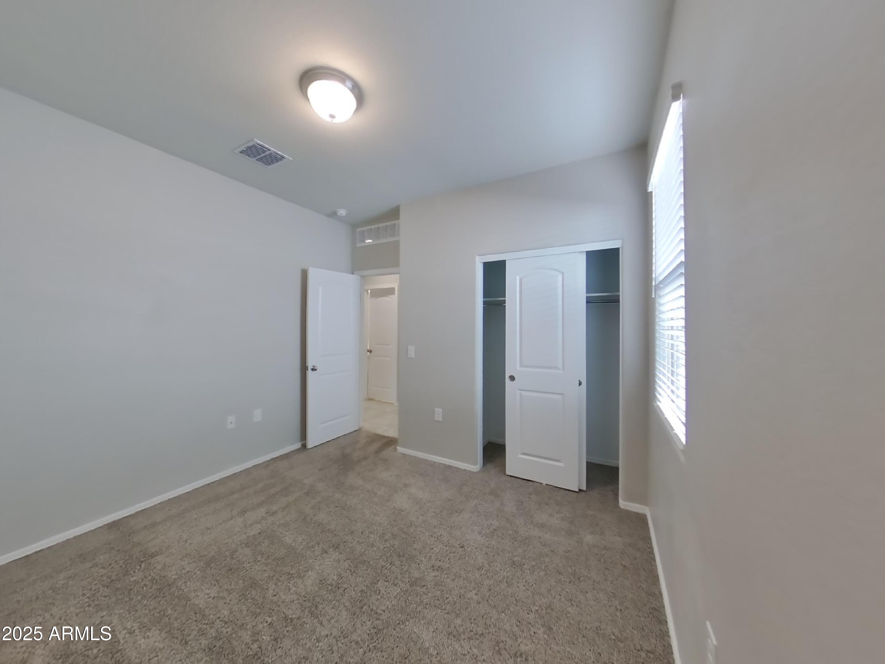 5288 Iridium Way San Tan Valley, AZ 85143 - Photo 11 of 16 a view of an empty room with a window
