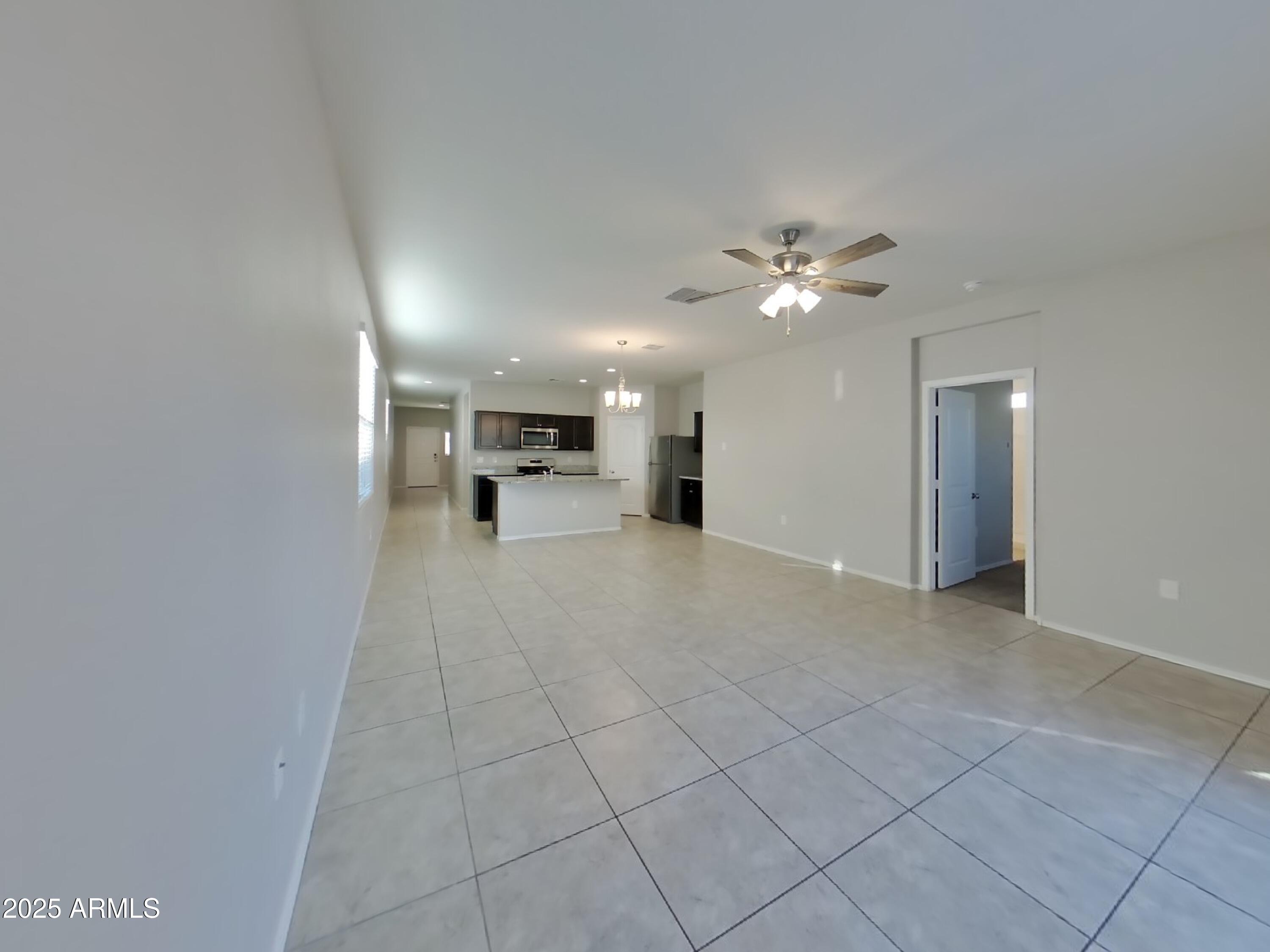 5288 Iridium Way San Tan Valley, AZ 85143 - Photo 3 of 16 a view of an empty room with a ceiling fan