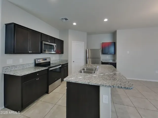a view of an empty room with a ceiling fan