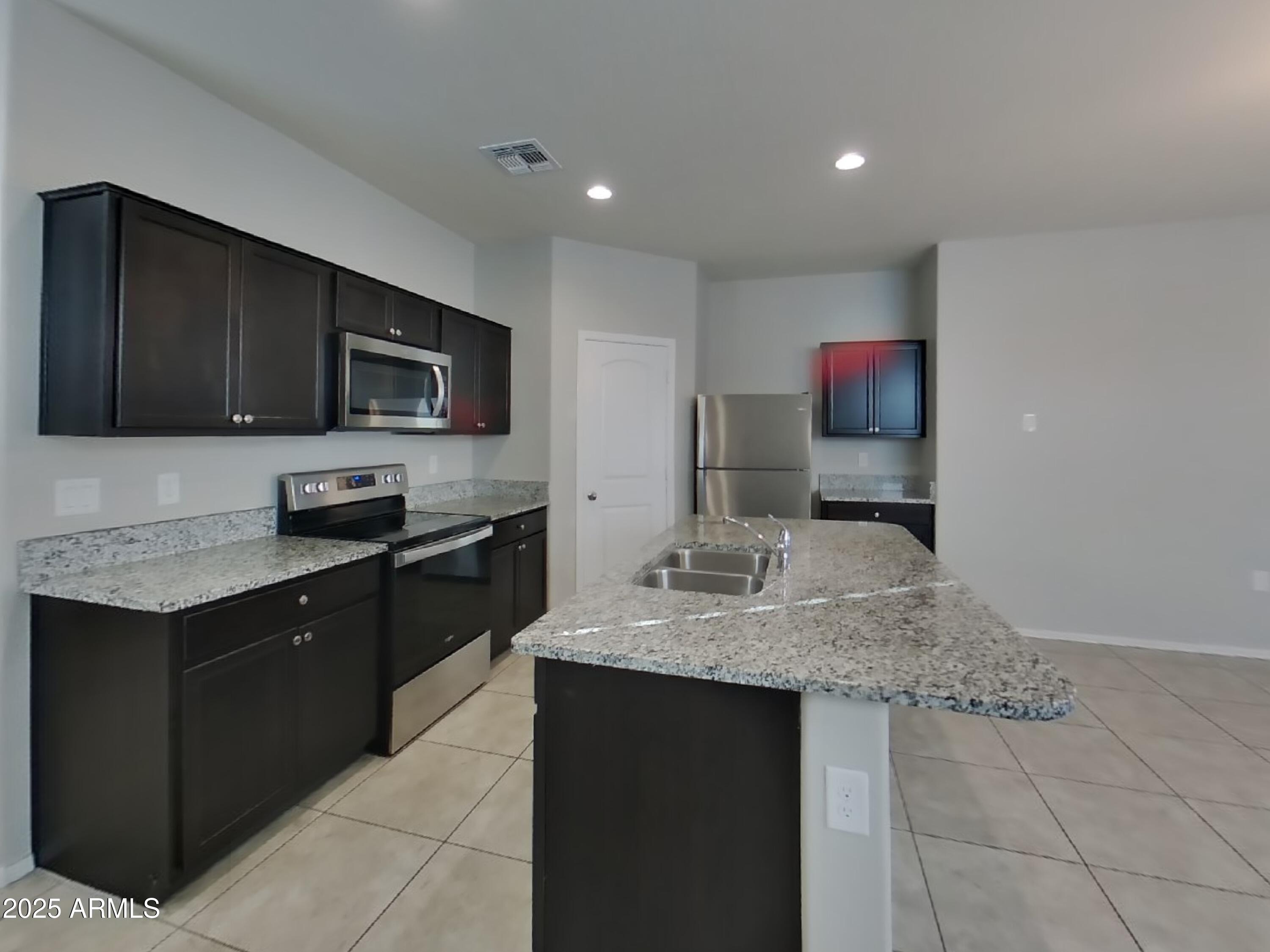 5288 Iridium Way San Tan Valley, AZ 85143 - Photo 4 of 16 a kitchen with a sink microwave and stove