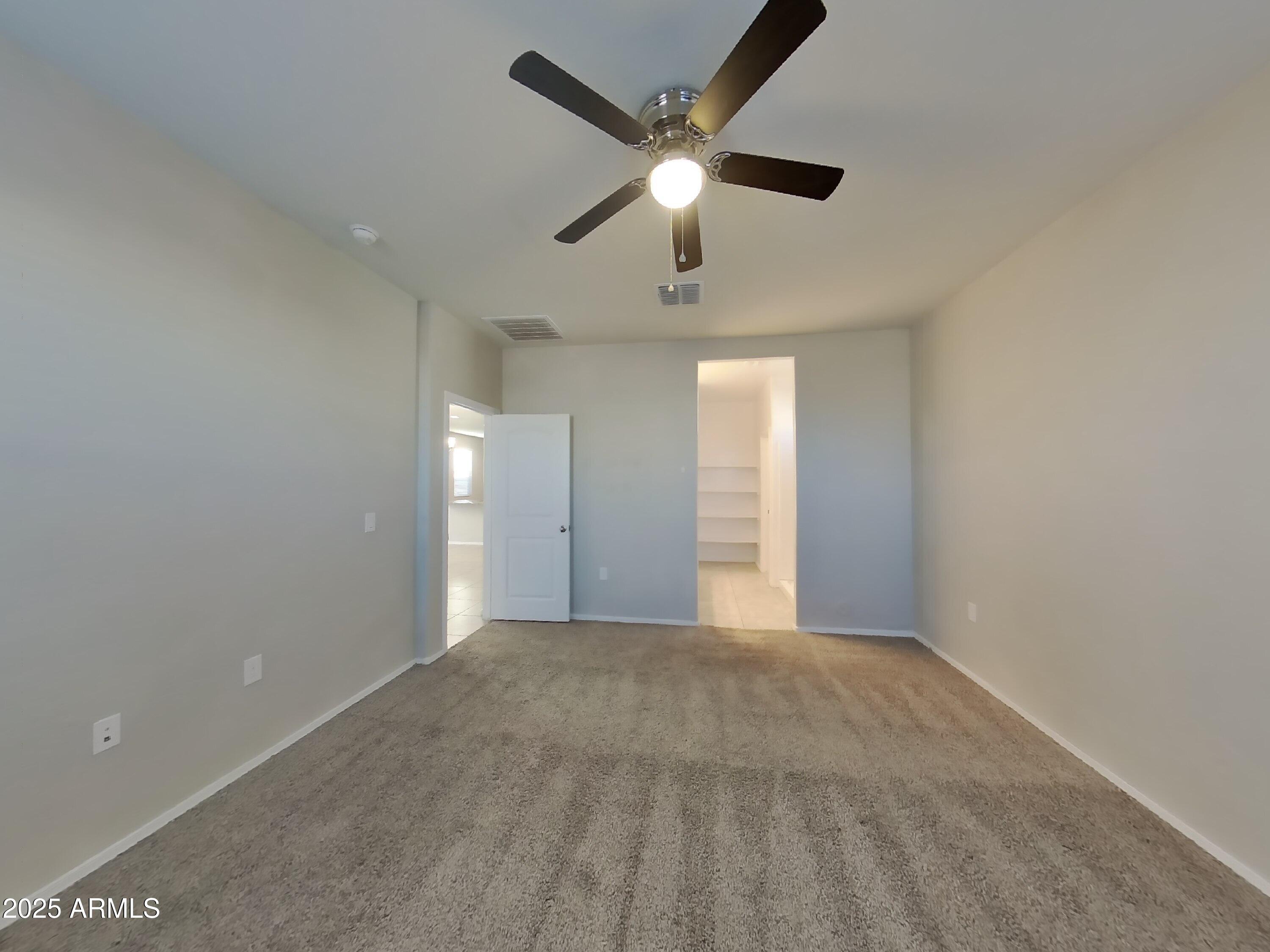 5288 Iridium Way San Tan Valley, AZ 85143 - Photo 5 of 16 an empty room with fan and windows