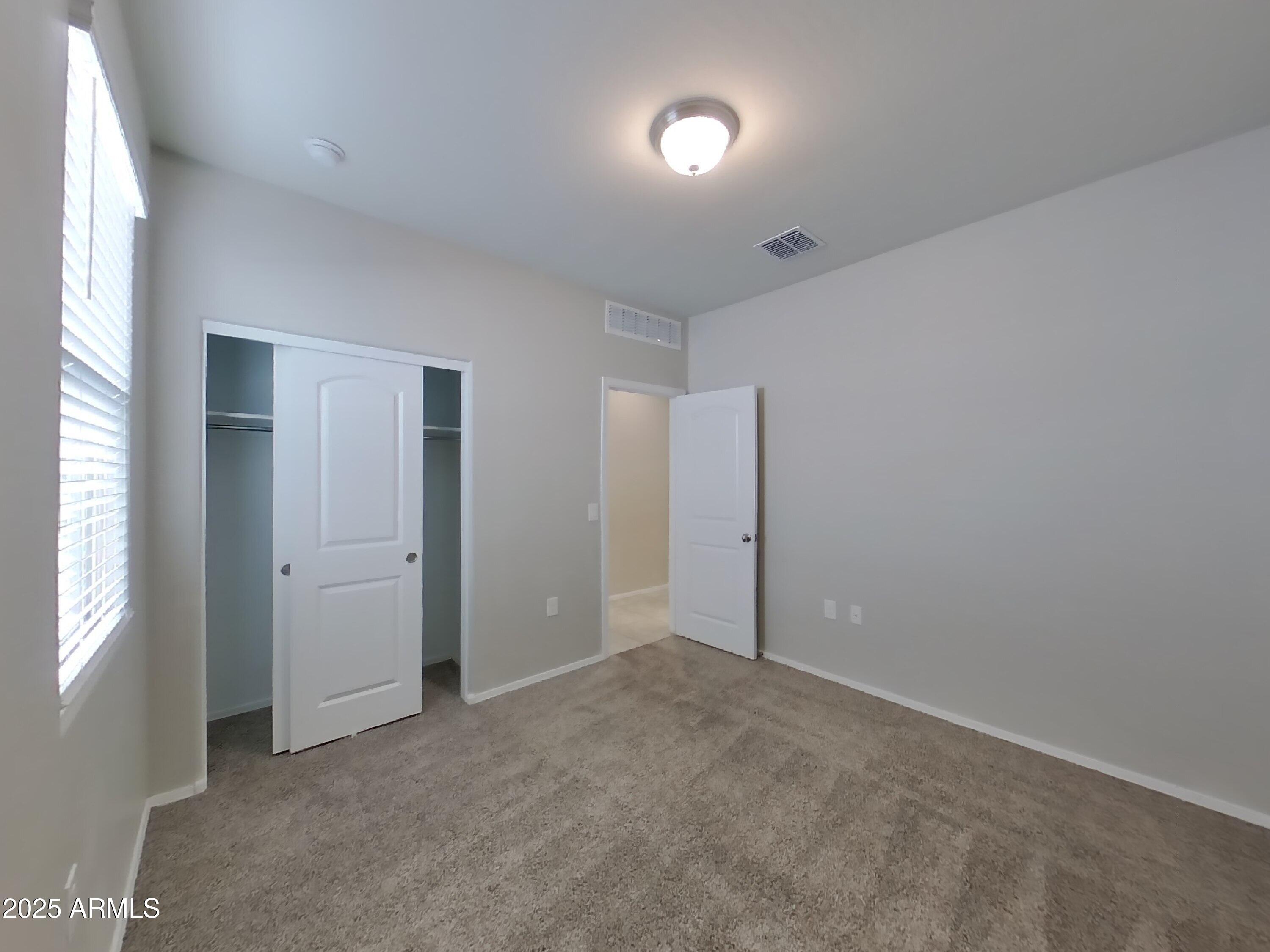 5288 Iridium Way San Tan Valley, AZ 85143 - Photo 7 of 16 an empty room with windows and closet