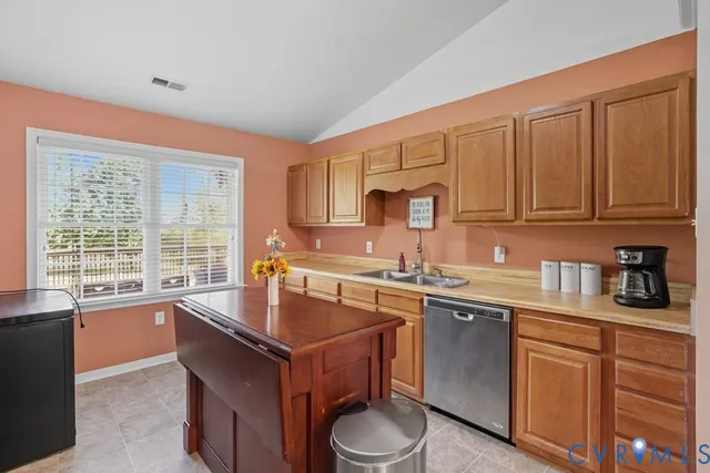a kitchen with stainless steel appliances a stove microwave and refrigerator