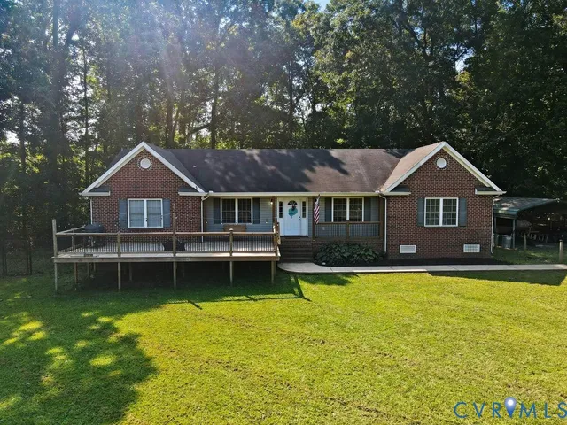 a aerial view of a house with swimming pool next to a big yard