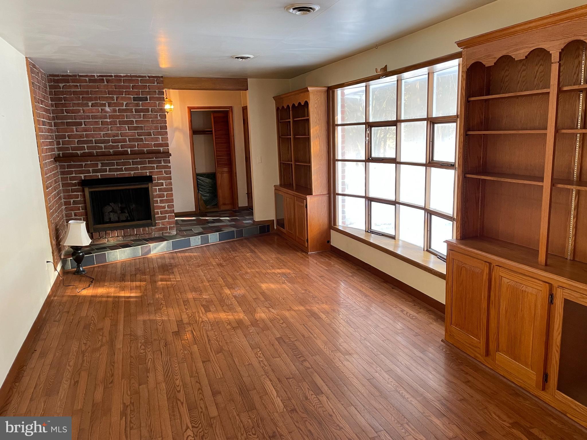 60 Ridge Road Gettysburg, PA 17325 - Photo 21 of 41 wooden floor fireplace and windows in an empty room