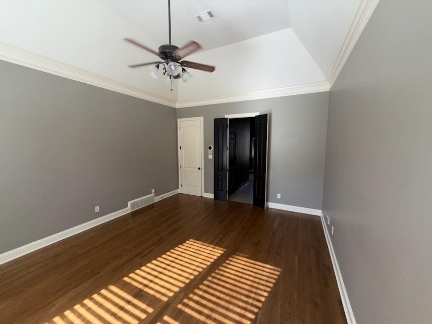 1307 Bull Creek Lane Collierville, TN 38017 - Photo 18 of 30 Unfurnished bedroom with crown molding, dark wood-style floors, and ceiling fan