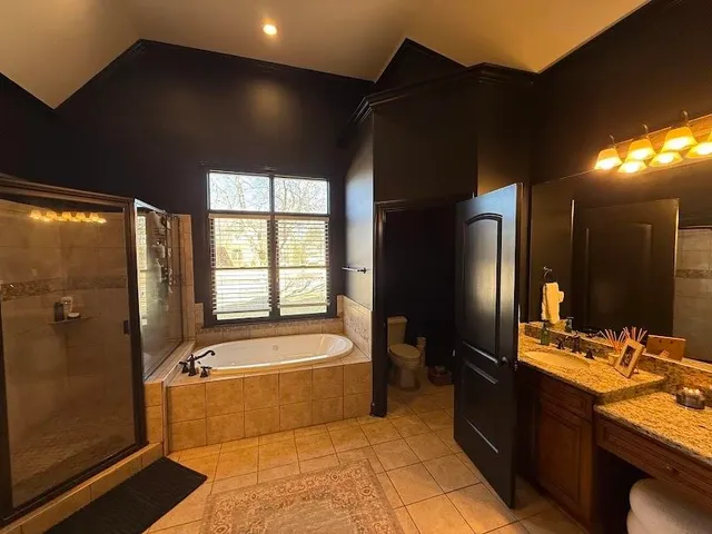 a bathroom with a tub a sink and a large mirror