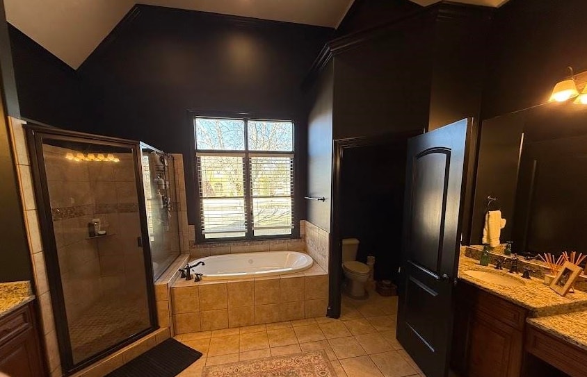 1307 Bull Creek Lane Collierville, TN 38017 - Photo 20 of 30 Bathroom with vanity, a shower stall, vaulted ceiling, a garden tub, and light tile patterned flooring