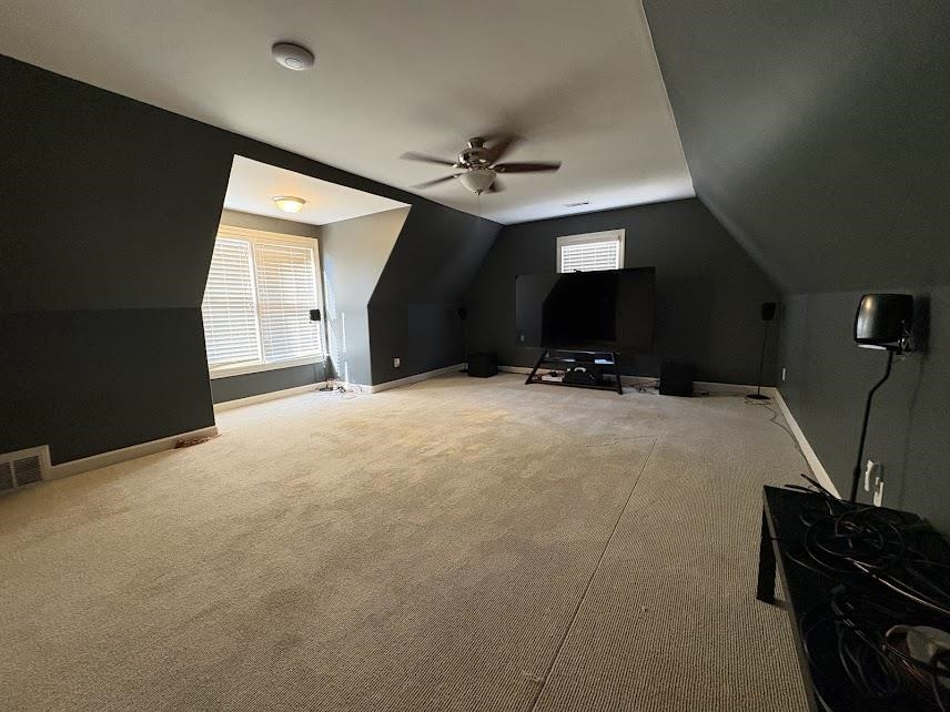 1307 Bull Creek Lane Collierville, TN 38017 - Photo 22 of 30 Bonus room featuring lofted ceiling, light carpet, and a ceiling fan