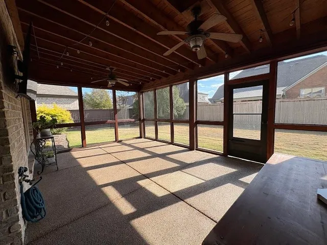 a bedroom with a bed with a large window