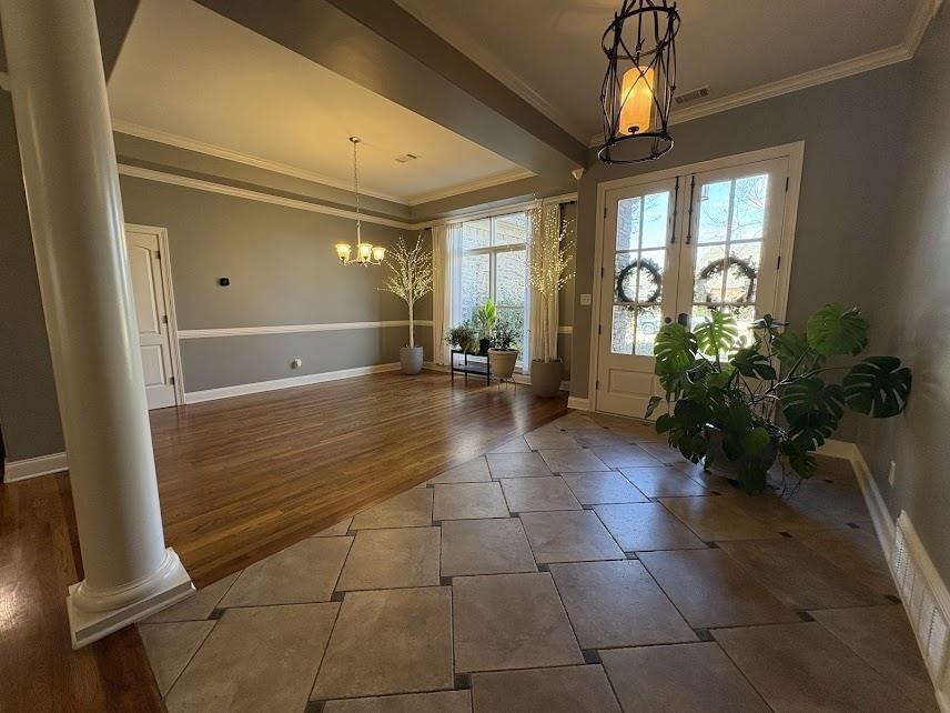 1307 Bull Creek Lane Collierville, TN 38017 - Photo 6 of 30 Tiled foyer entrance featuring crown molding, a chandelier, a raised ceiling, and ornate columns