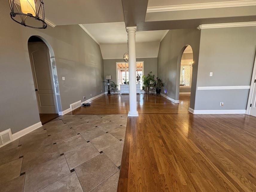 1307 Bull Creek Lane Collierville, TN 38017 - Photo 7 of 30 Entrance foyer with arched walkways, ornamental molding, a chandelier, wood finished floors, and lofted ceiling
