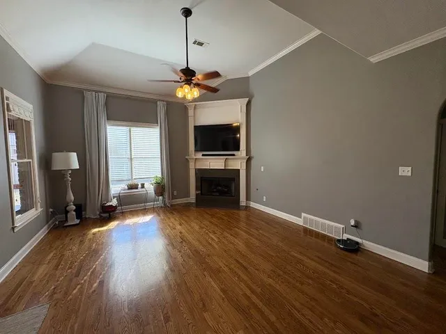 a view of a livingroom with hardwood floor and a ceiling fan