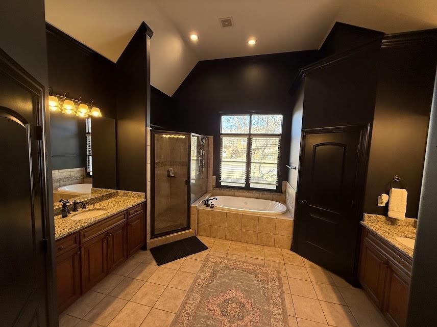 1307 Bull Creek Lane Collierville, TN 38017 - Photo 10 of 30 Full bathroom with two vanities, a stall shower, lofted ceiling, a bath, and light tile patterned flooring