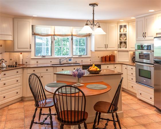 39 Mast Hill Road Hingham, MA 02043 - Photo 6 of 13 a kitchen with stainless steel appliances granite countertop a stove a sink a stove a dining table and chairs
