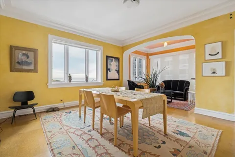 a living room with fireplace furniture and a table