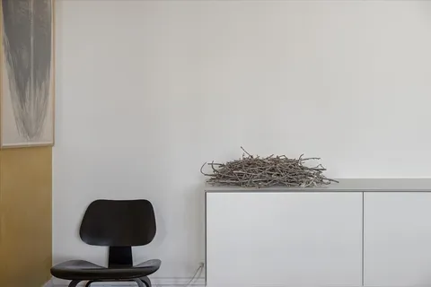 a living room with furniture and a book shelf