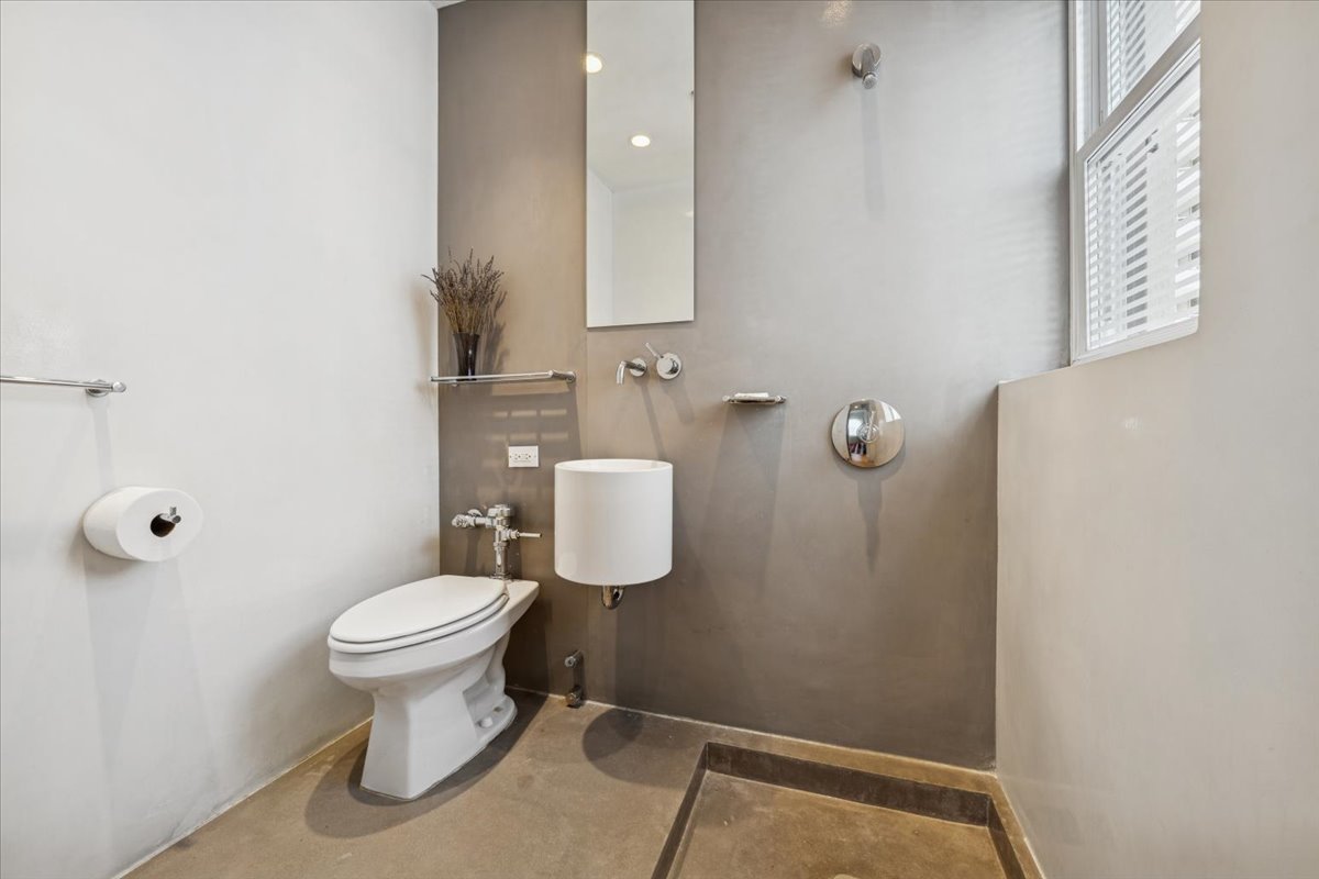 707 West Jr Terrace, Unit 10 Chicago, IL 60613 - Photo 38 of 42 a bathroom with a toilet sink and mirror