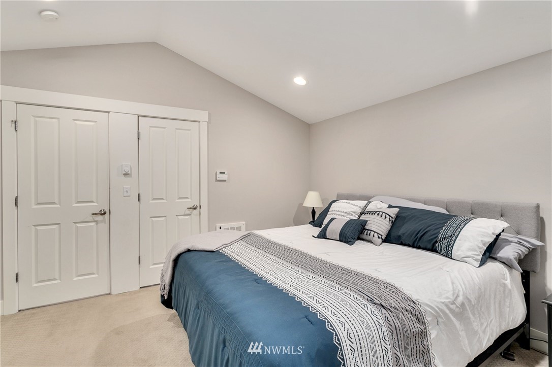 10303 Holman Road North, Unit C Seattle, WA 98177 - Photo 14 of 23 a bedroom with a bed and a closet