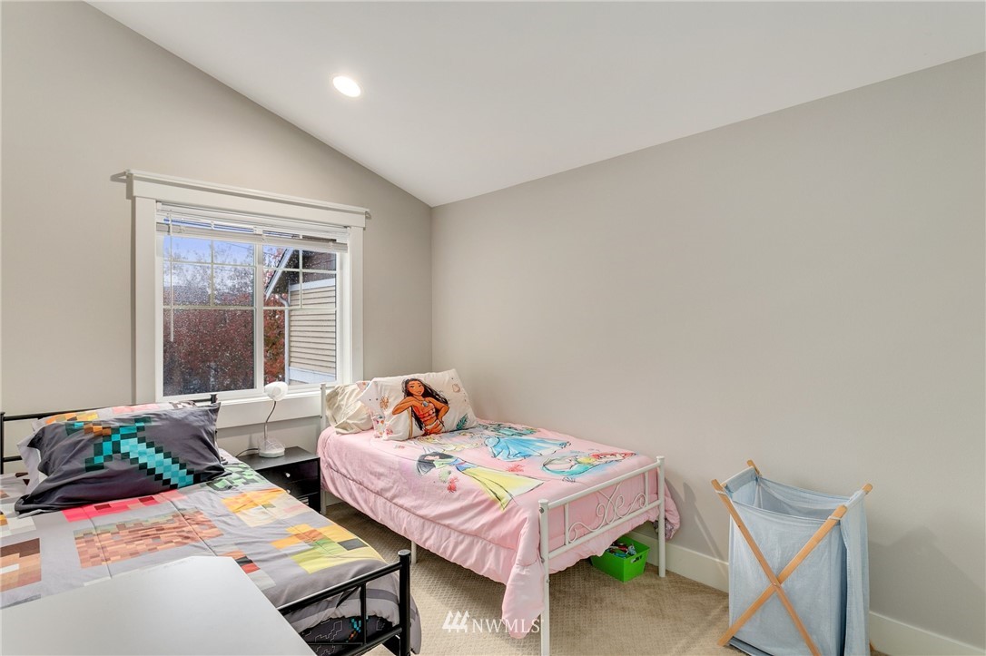 10303 Holman Road North, Unit C Seattle, WA 98177 - Photo 16 of 23 a bedroom with a bed and a table in it
