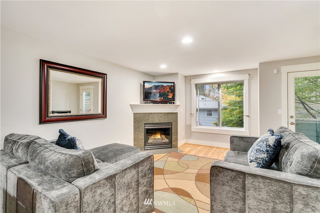 10303 Holman Road North, Unit C Seattle, WA 98177 - Photo 3 of 23 a living room with furniture and a fireplace