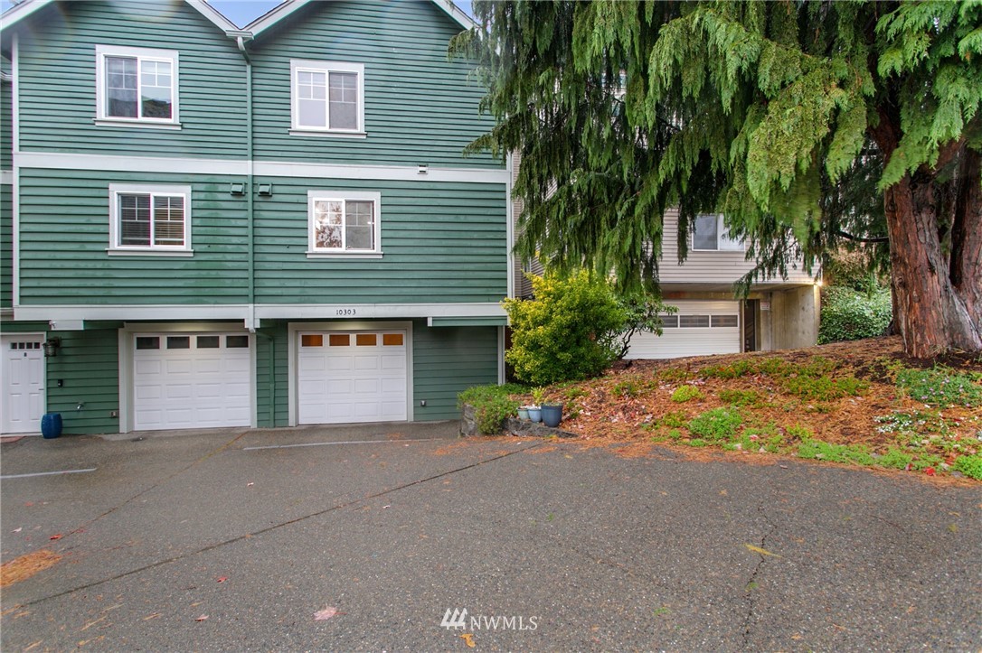 10303 Holman Road North, Unit C Seattle, WA 98177 - Photo 23 of 23 a front view of a house with a yard and garage
