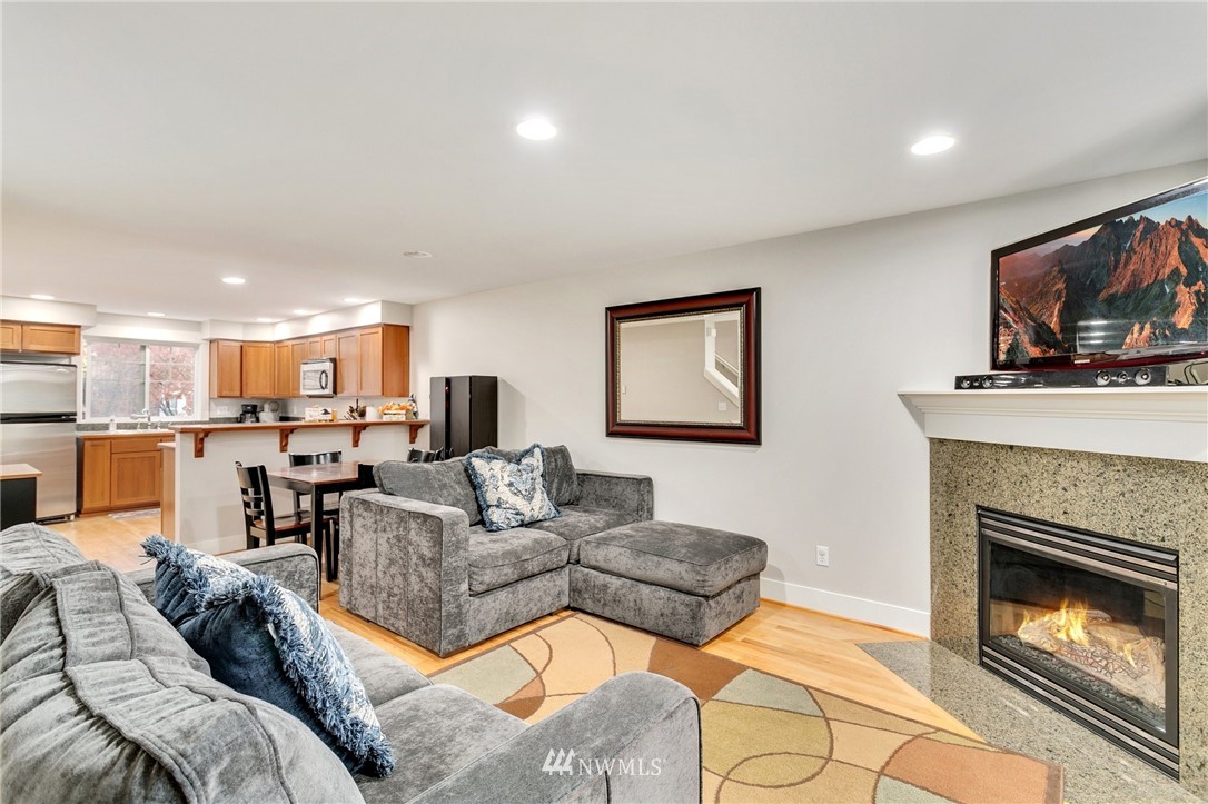 10303 Holman Road North, Unit C Seattle, WA 98177 - Photo 4 of 23 a living room with furniture fireplace and flat screen tv