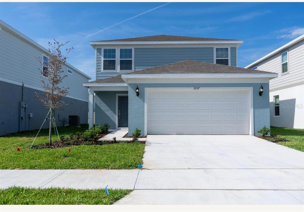 2007 Alluring Lane Davenport, FL 33896 - Photo 1 of 31 a front view of a house with garden