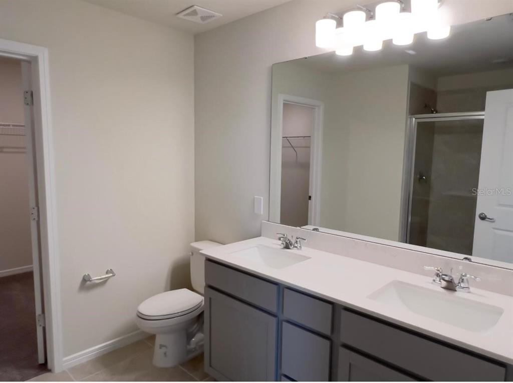 2007 Alluring Lane Davenport, FL 33896 - Photo 17 of 31 a bathroom with a sink and a mirror