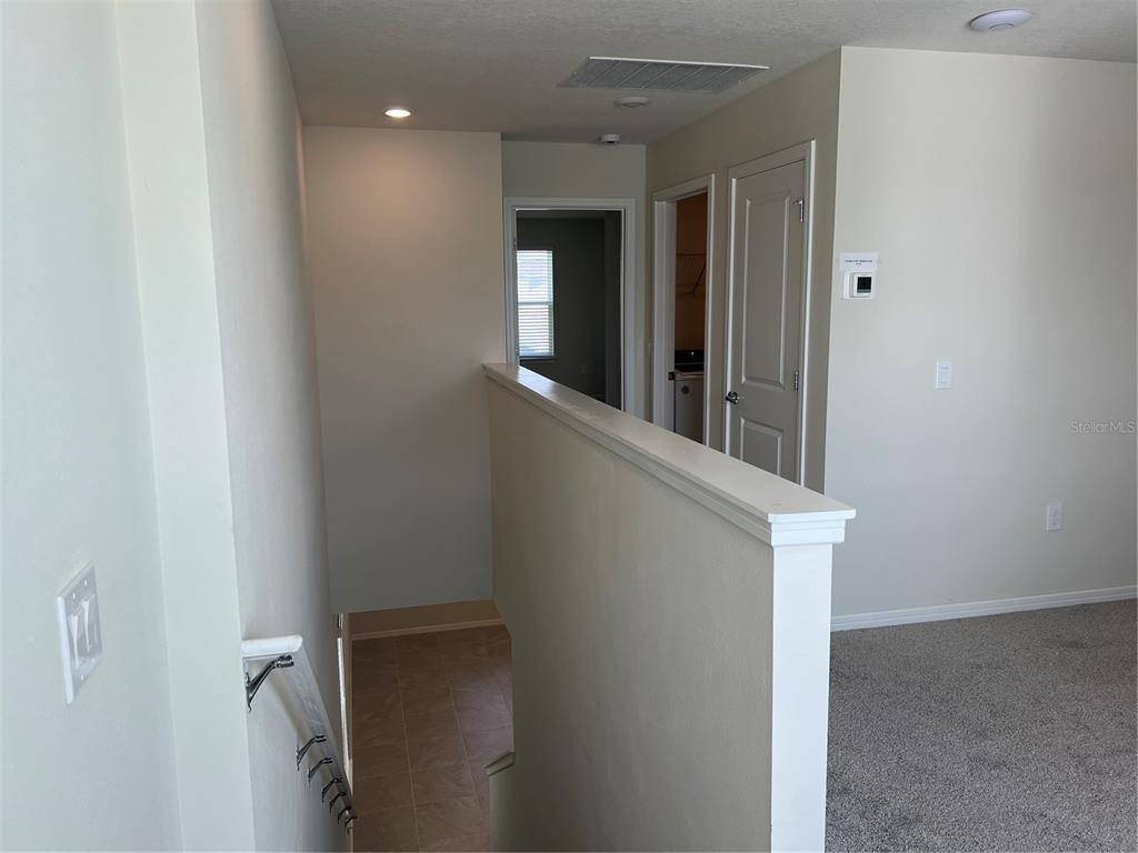 2007 Alluring Lane Davenport, FL 33896 - Photo 19 of 31 a view of hallway with chandelier