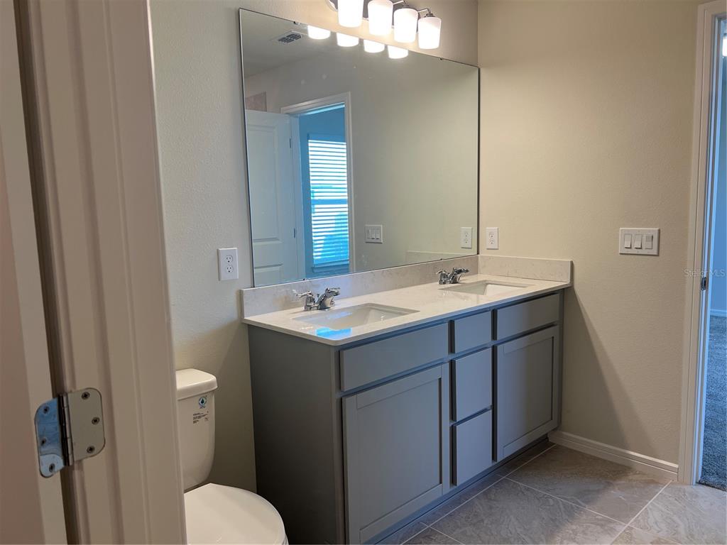 2007 Alluring Lane Davenport, FL 33896 - Photo 22 of 31 a bathroom with a sink and a toilet
