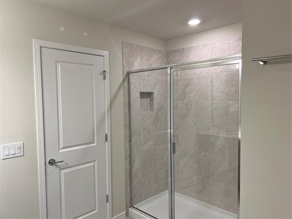 2007 Alluring Lane Davenport, FL 33896 - Photo 23 of 31 a bathroom with a glass shower door