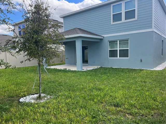 an aerial view of a house with outdoor space